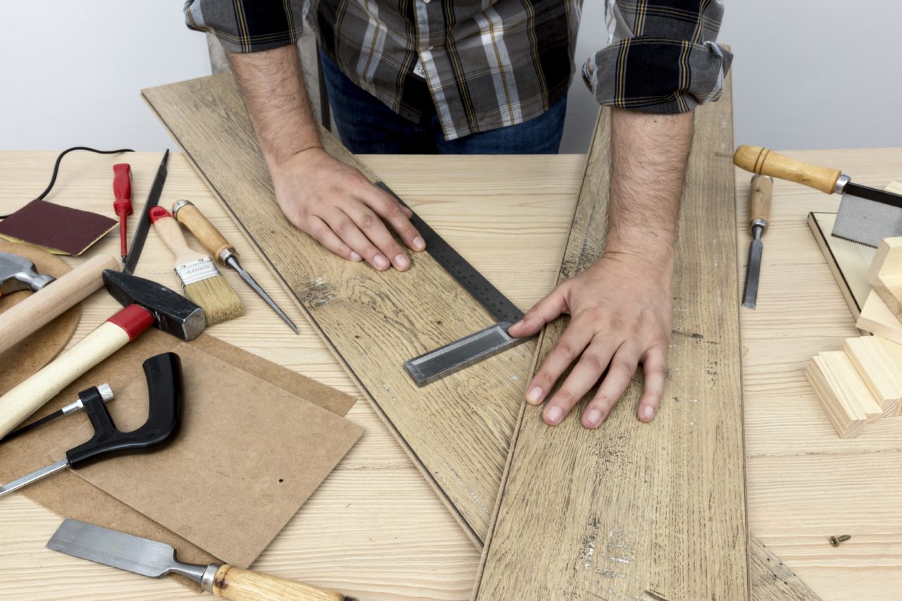 high-view-holding-wood-planks-carpentry-workshop-concept-1280x853.jpg